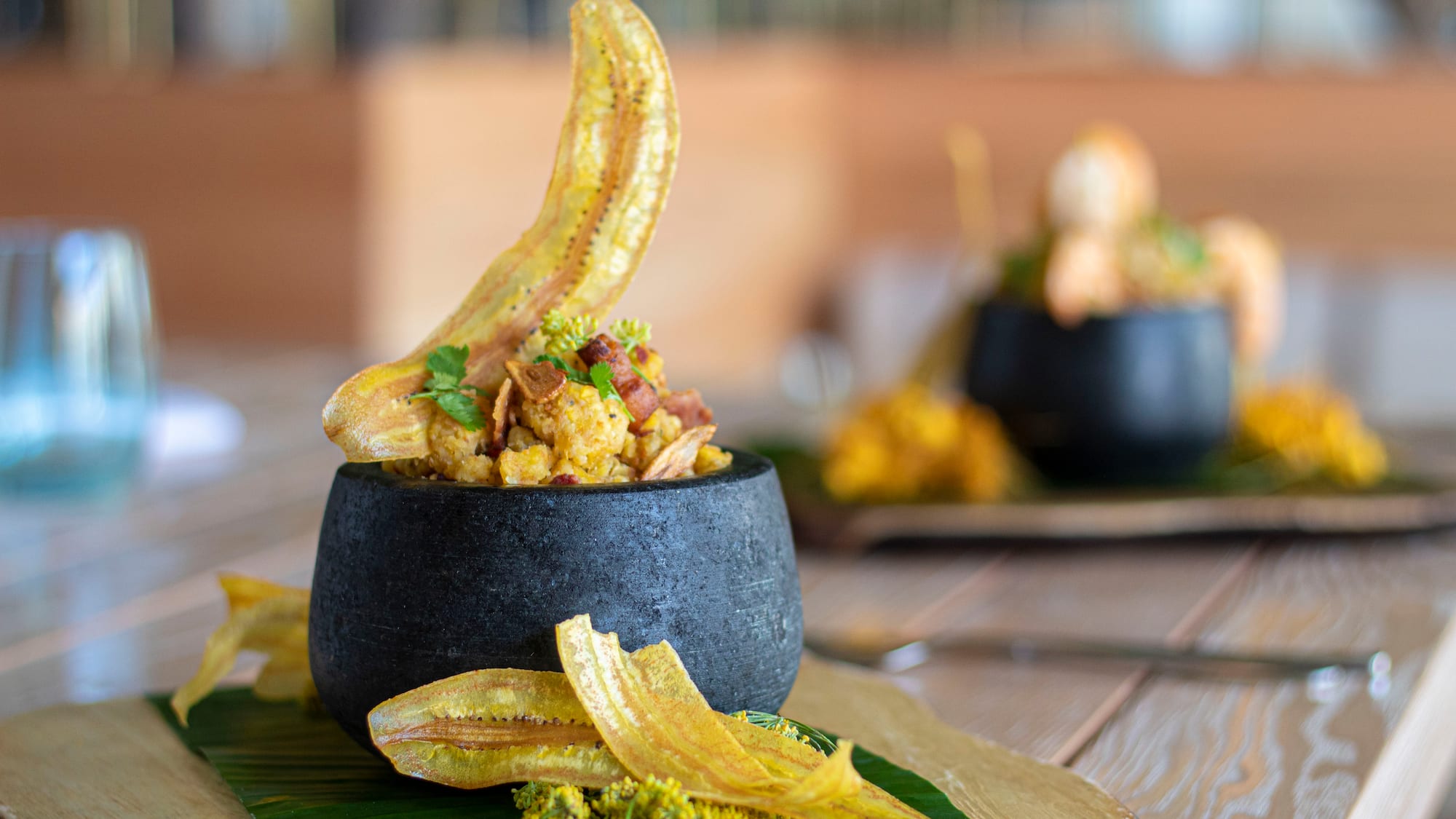 a bowl of food on a leafy surface
