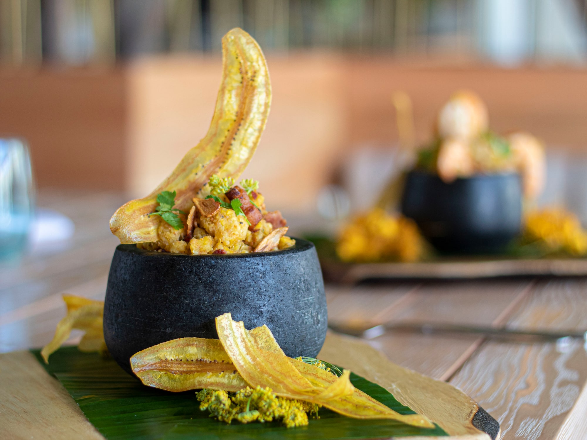 a bowl of food on a leafy surface