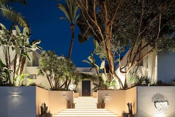 a white building with trees and stairs