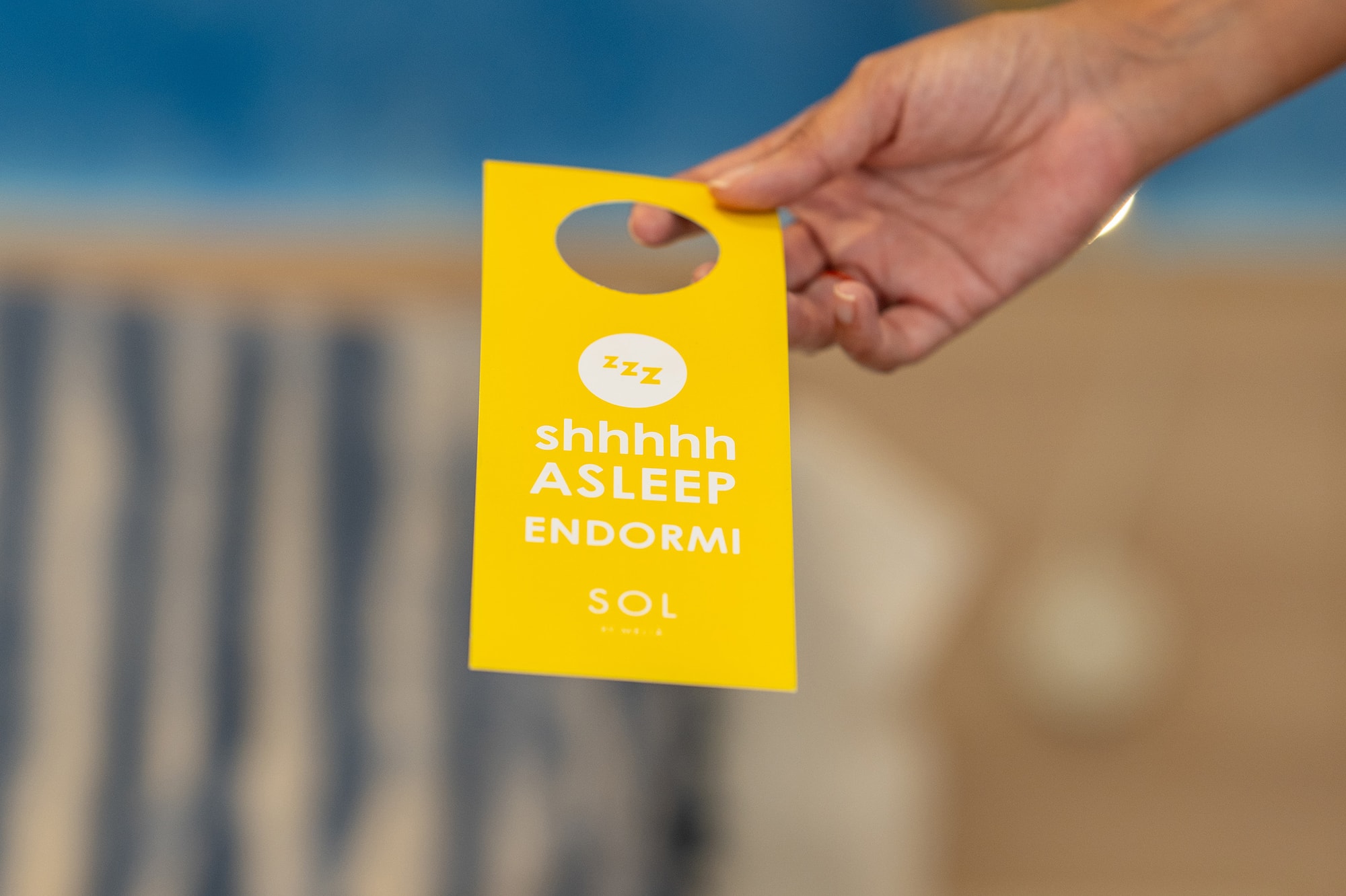 a hand holding a yellow tag