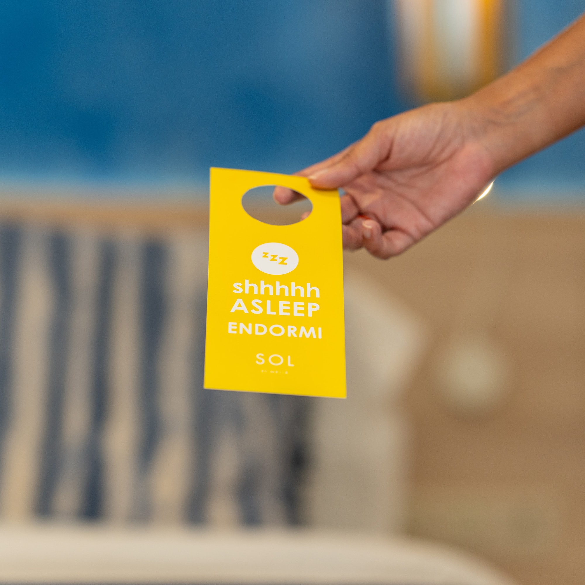 a hand holding a yellow tag