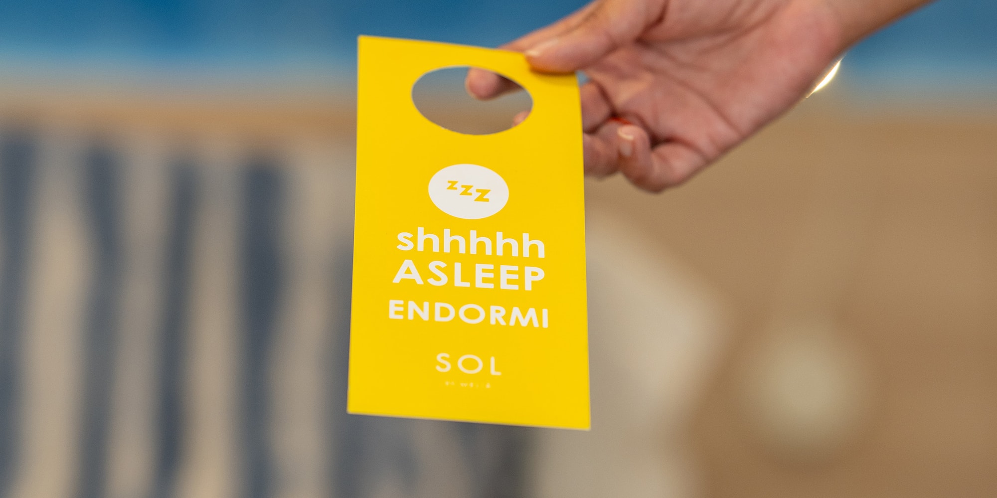 a hand holding a yellow tag