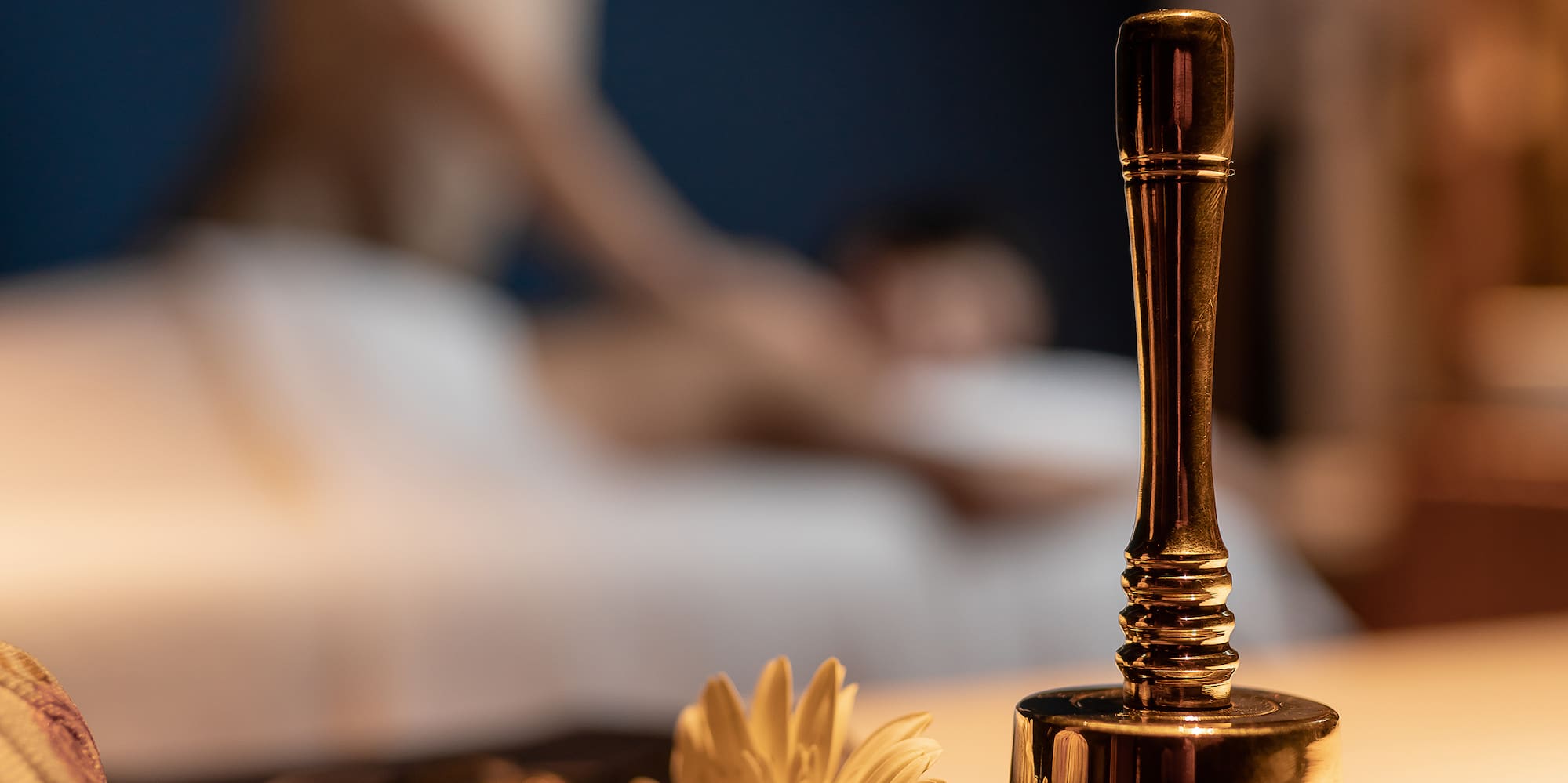 a bell and flower on a table