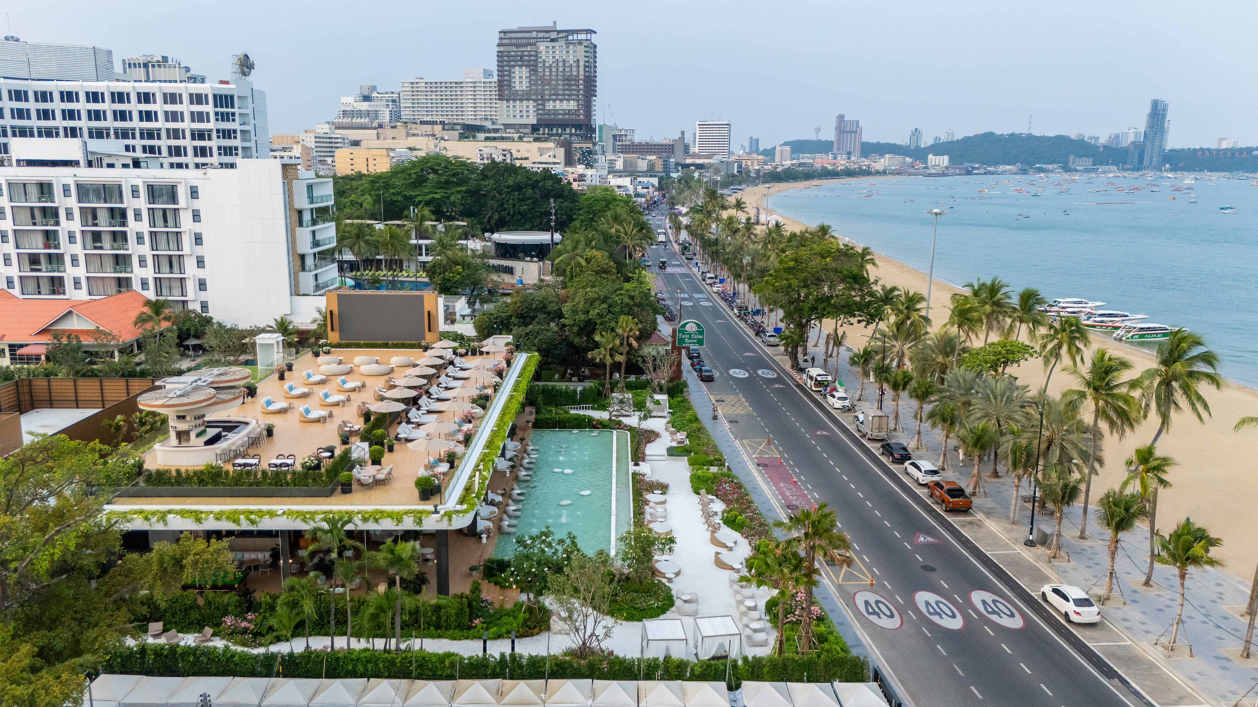 Pattaya Beach resort and city from above, with road, beach, and ocean.