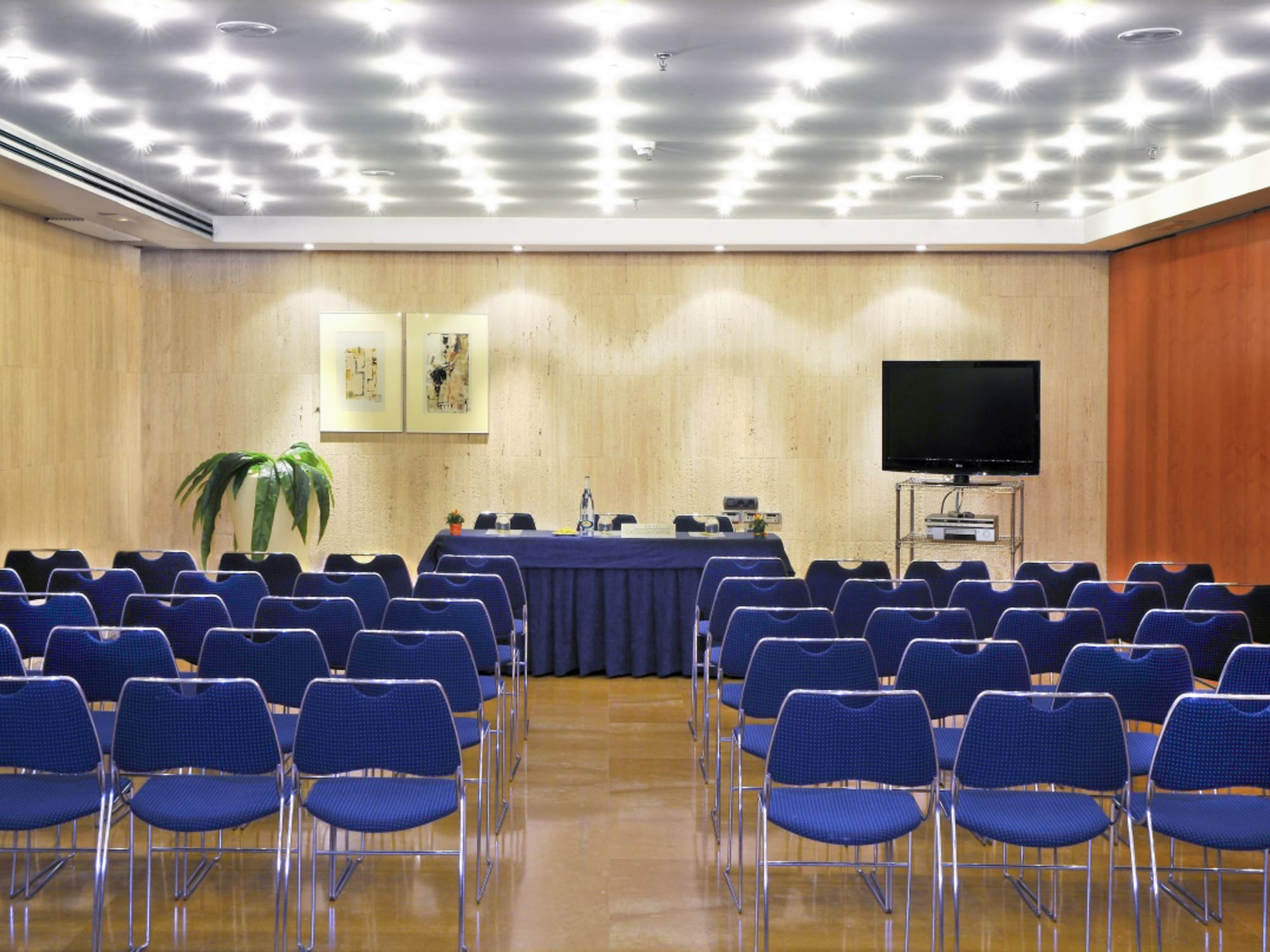 a room with blue chairs and a table