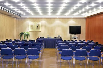 a room with blue chairs and a table