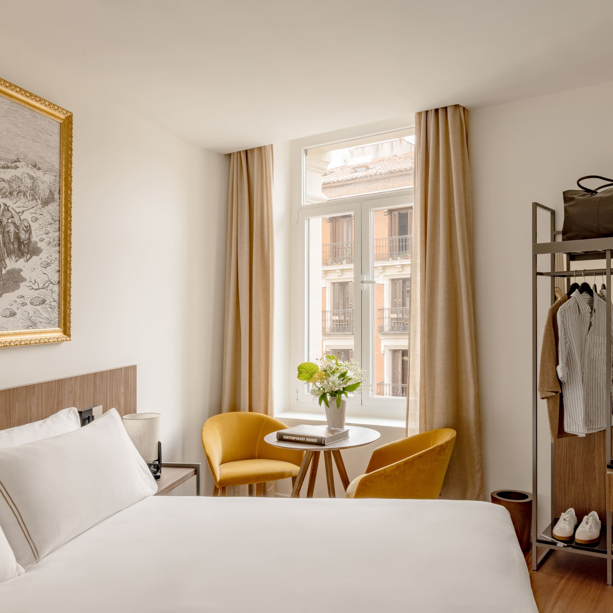 a room with a bed and a table and chairs