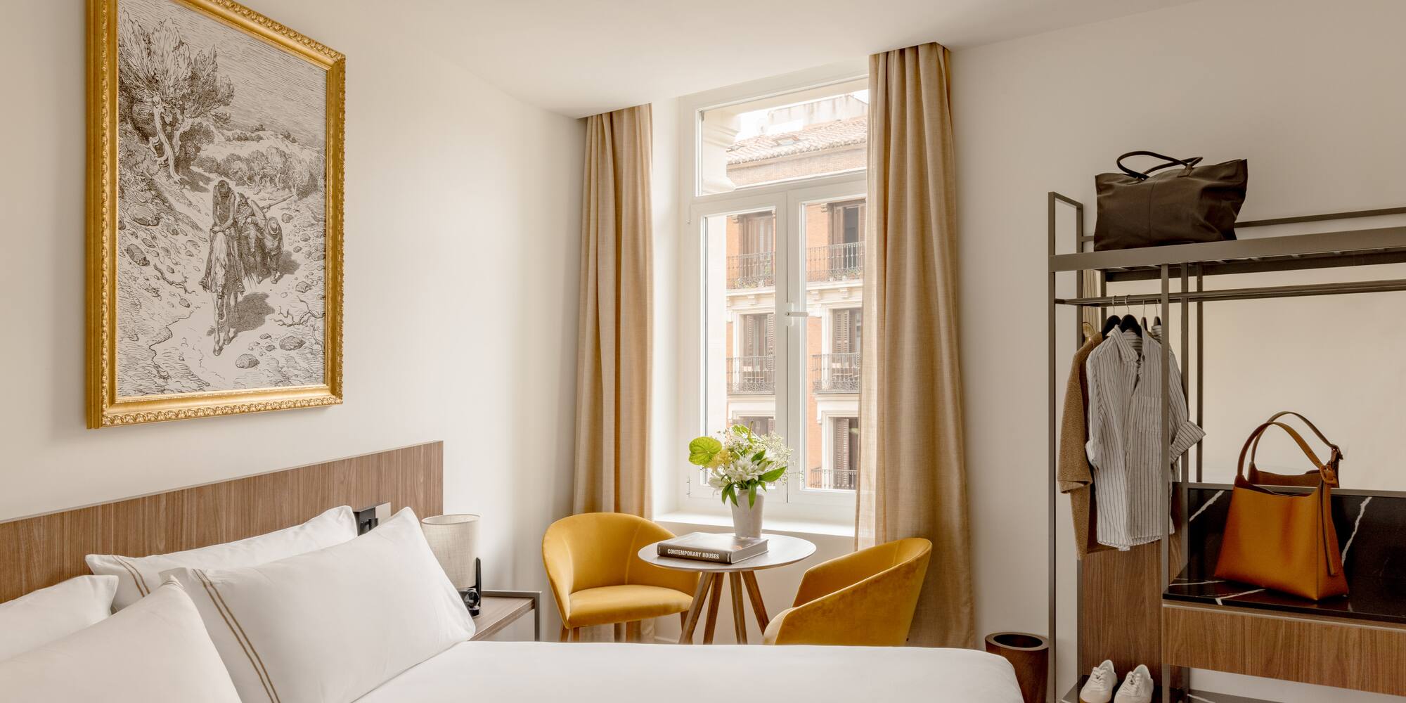 a room with a bed and a table and chairs