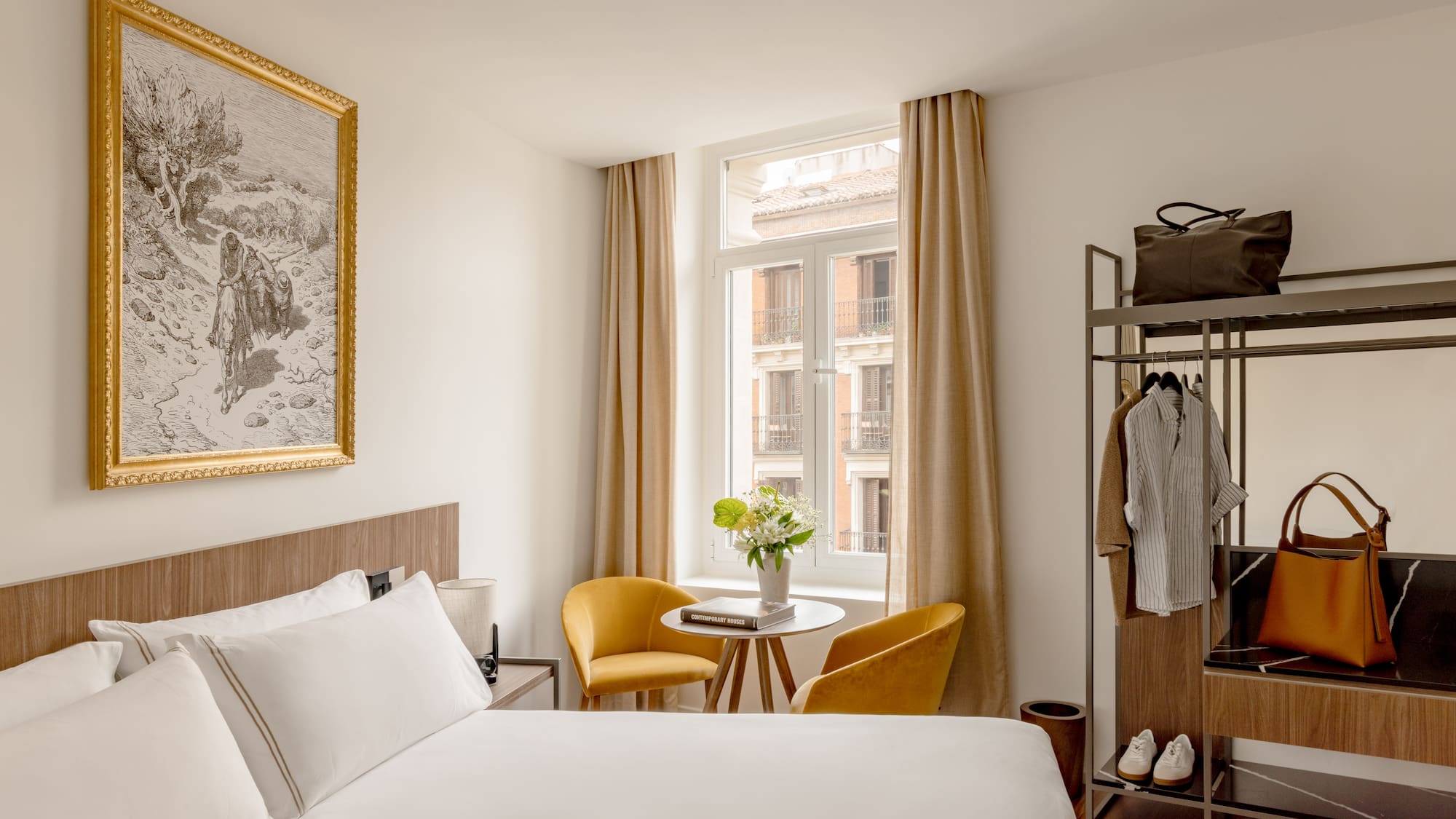 a room with a bed and a table and chairs