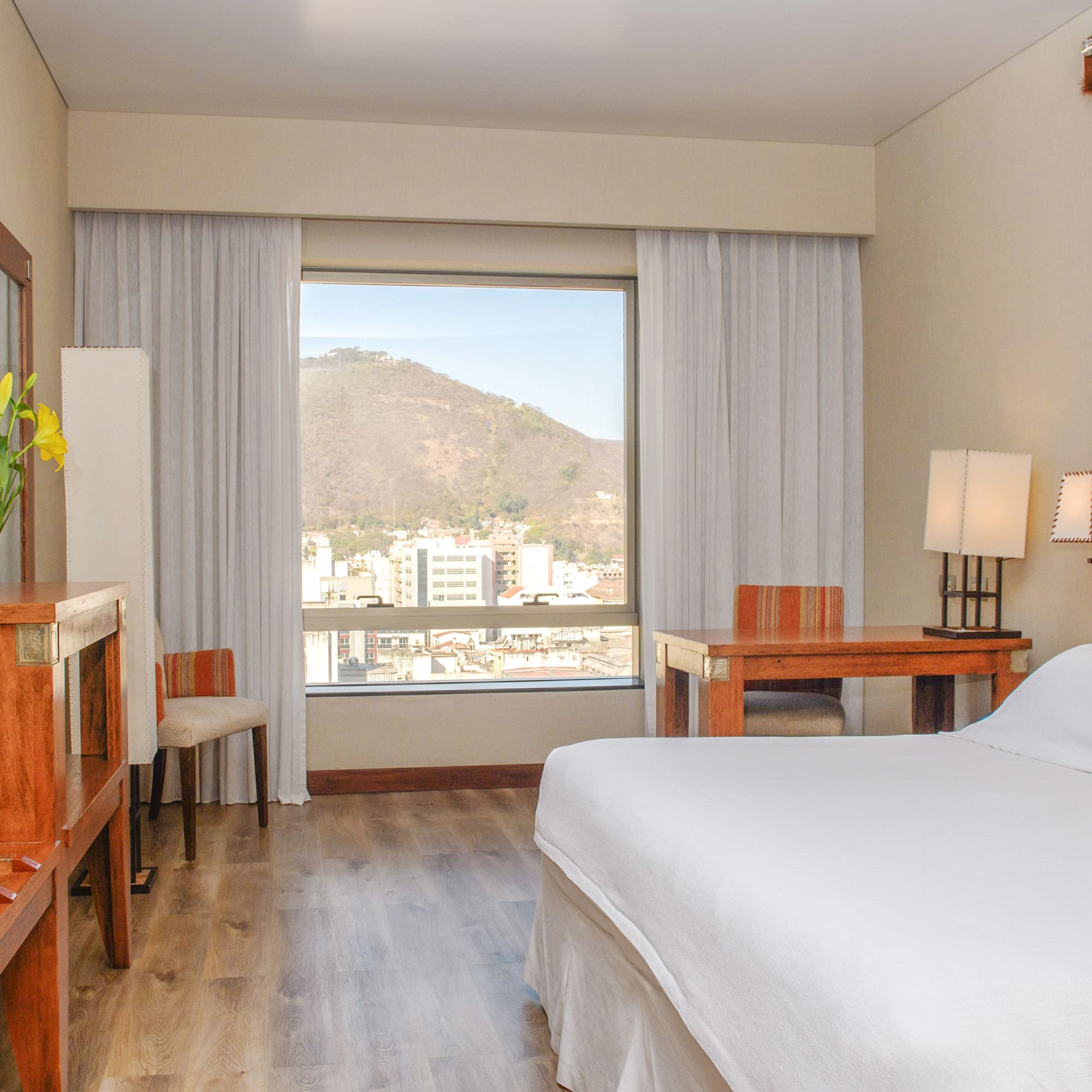 a room with a bed and a table and chairs