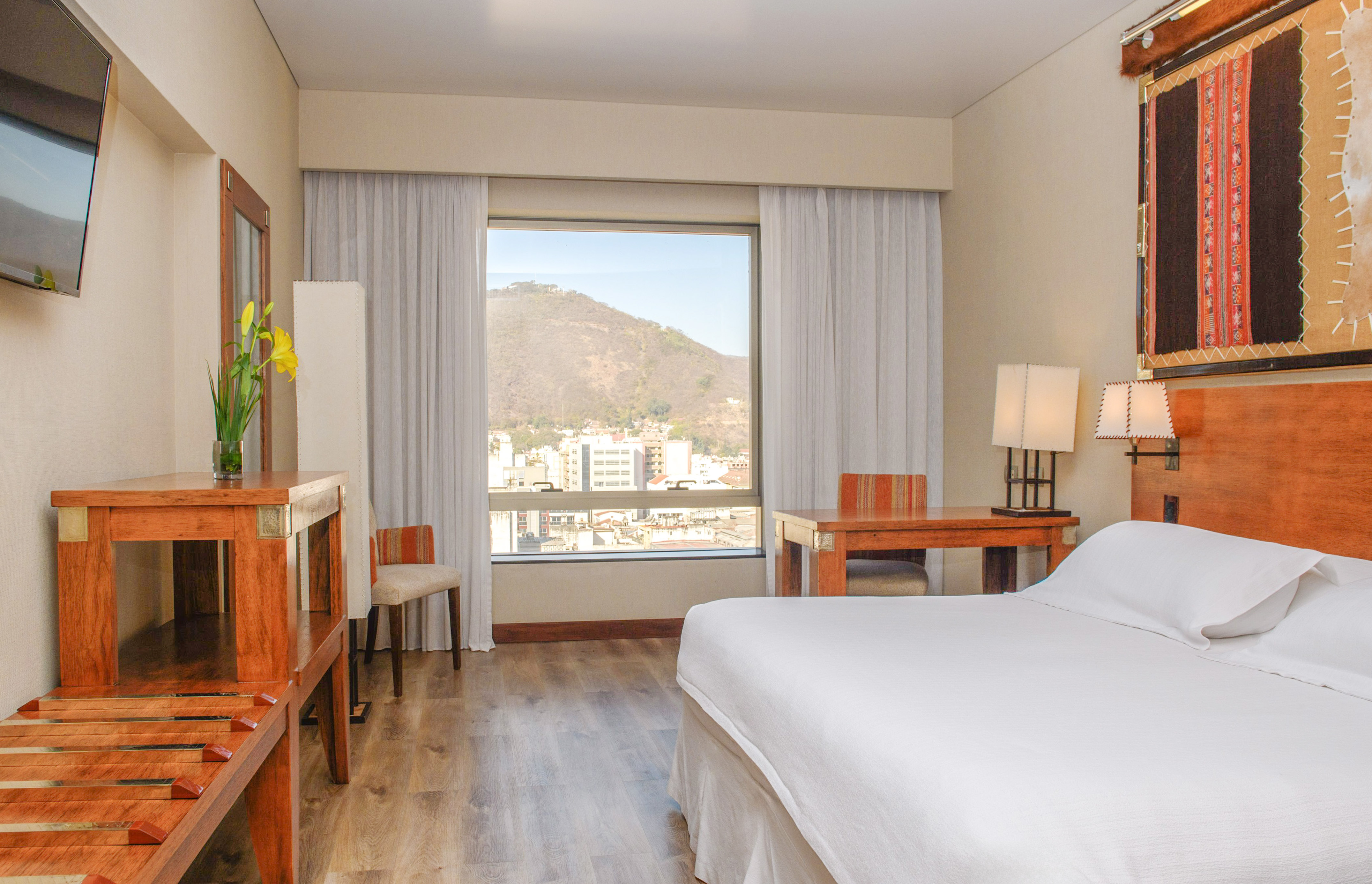 a room with a bed and a table and chairs