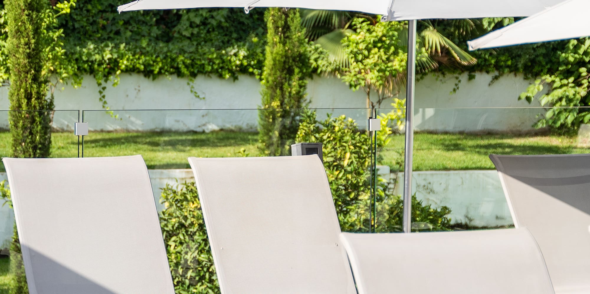 a group of chairs and umbrellas on a patio