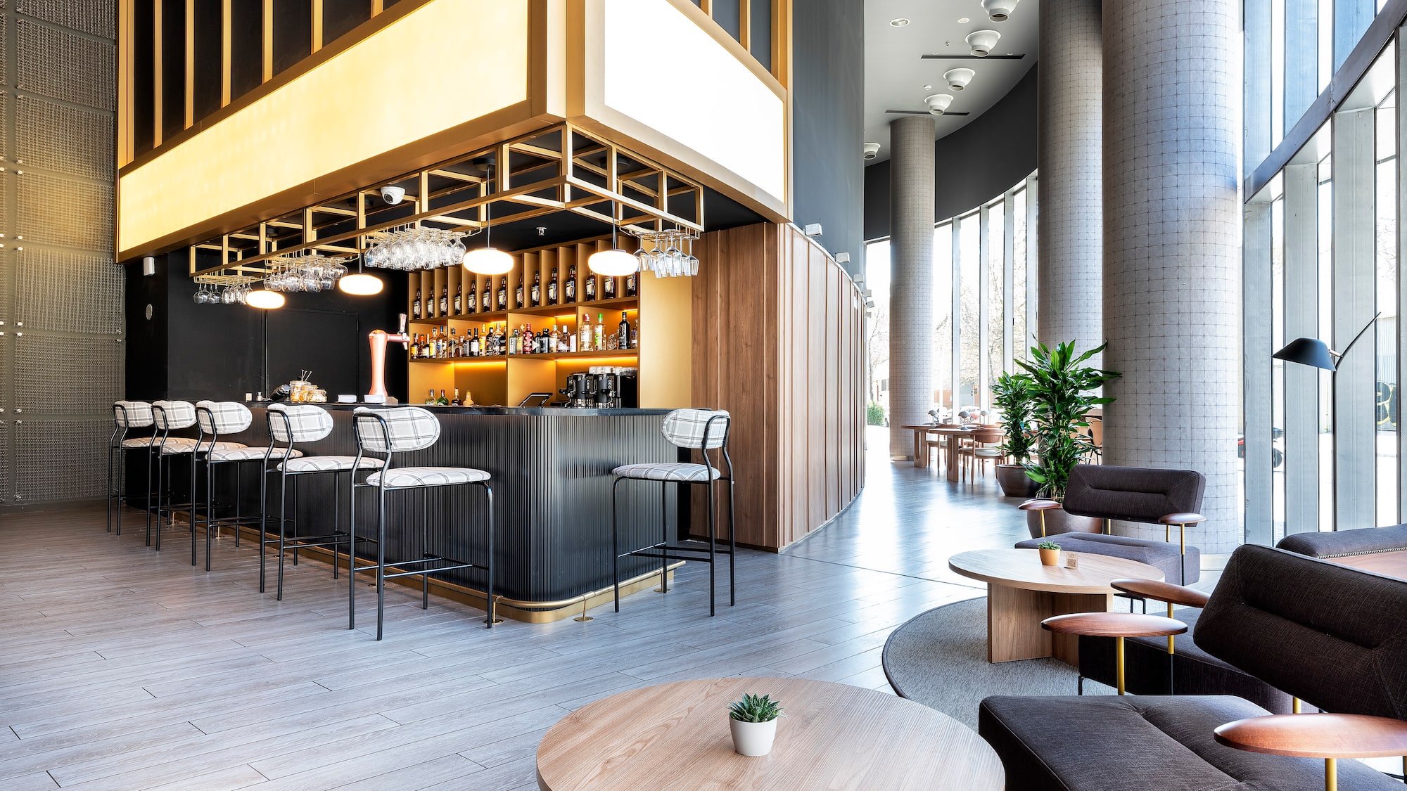 a room with a bar and chairs