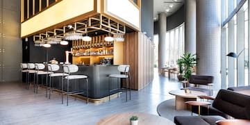 a room with a bar and chairs