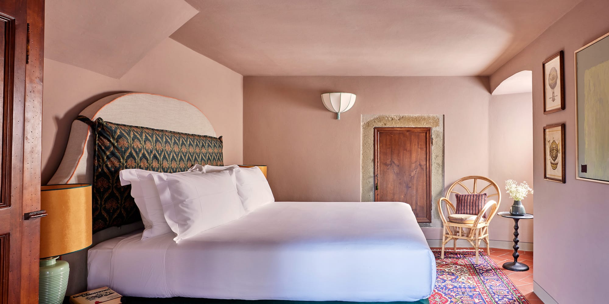 a room with a bed and chairs