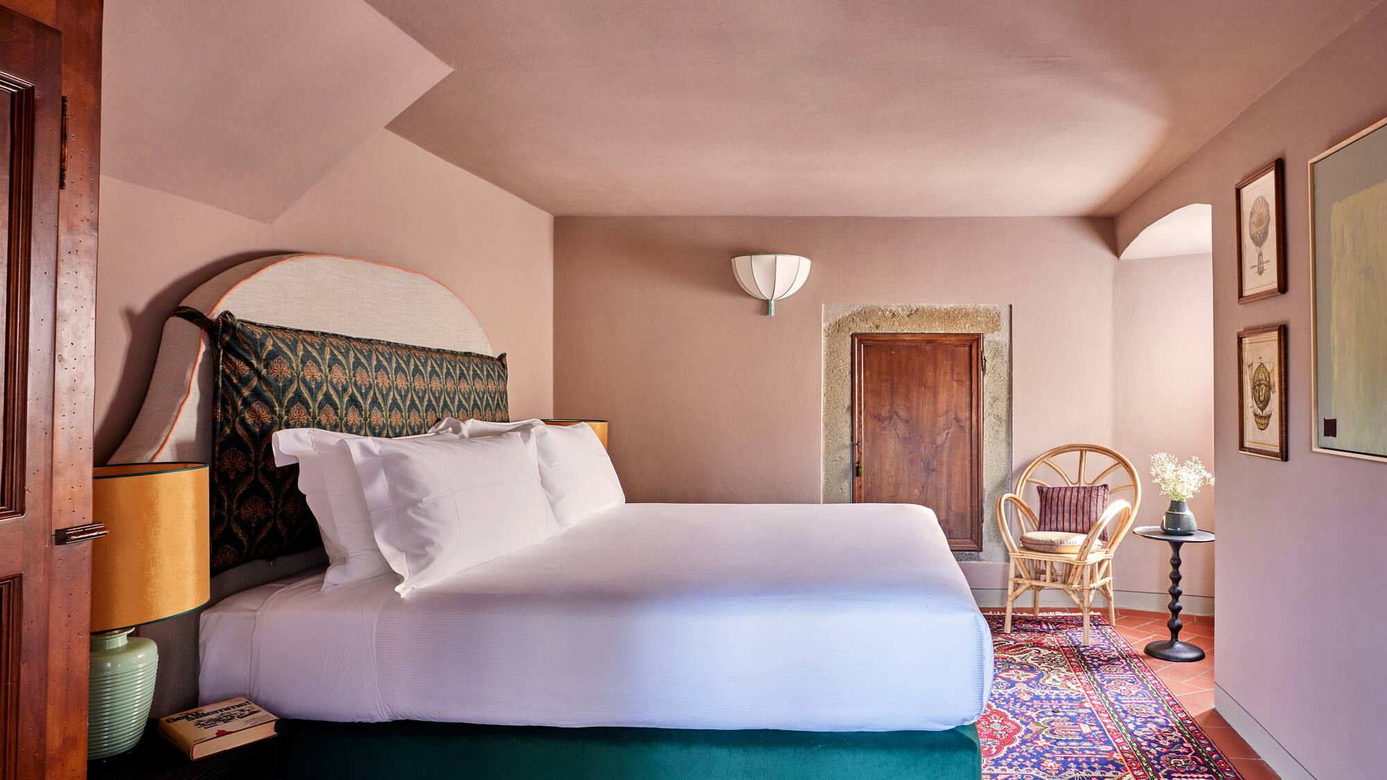 a room with a bed and chairs