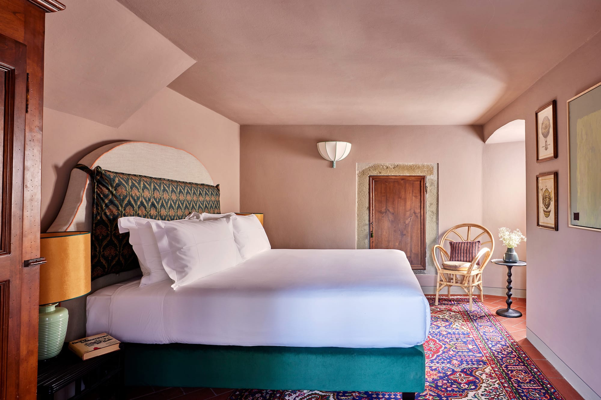 a room with a bed and chairs