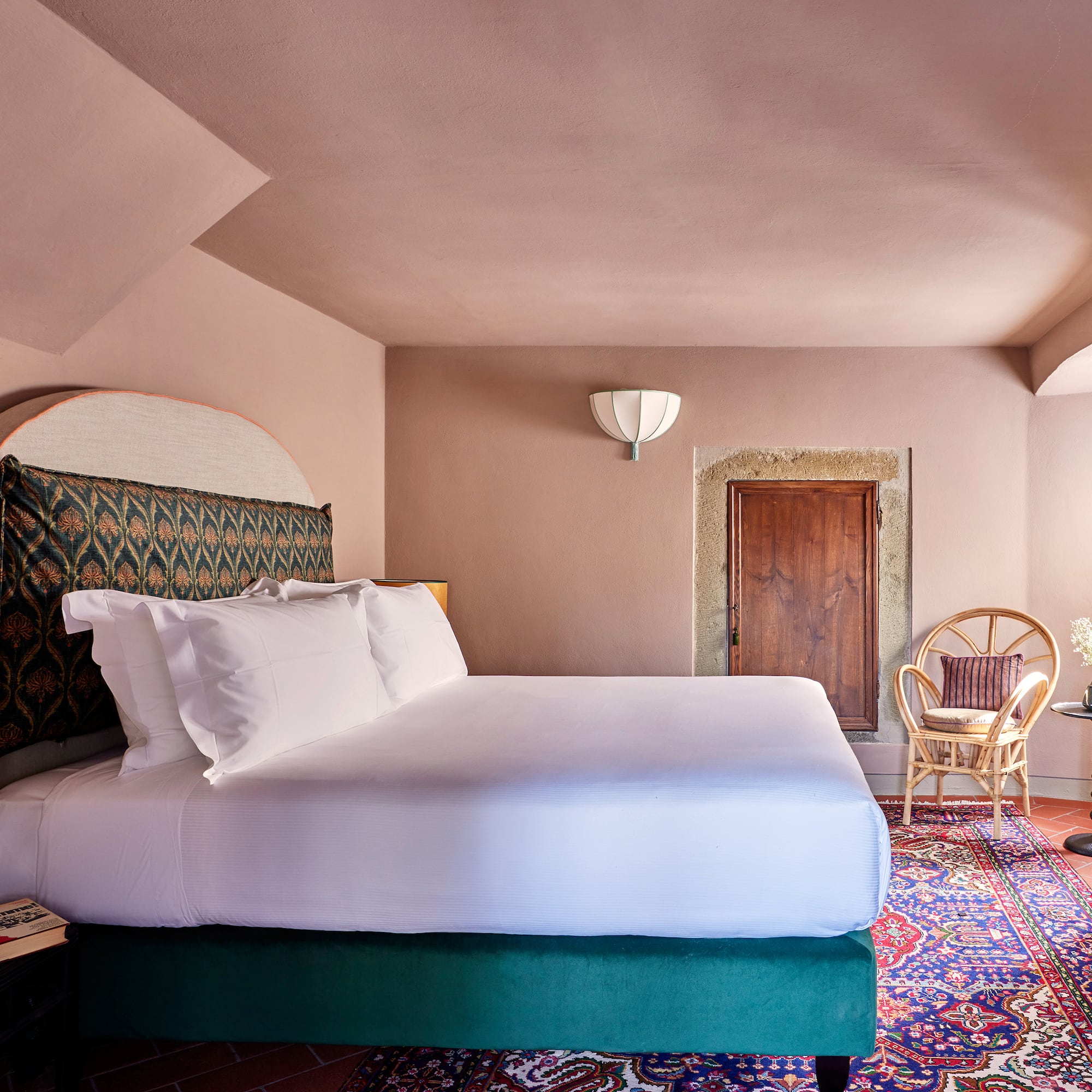 a room with a bed and chairs