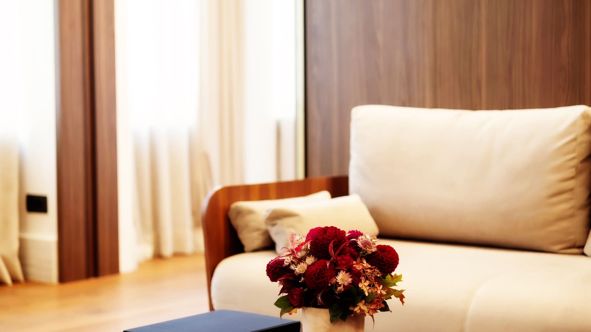 a vase of flowers on a coffee table in a living room