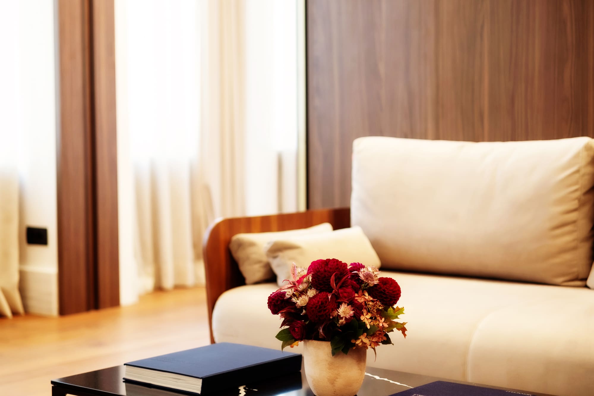 a vase of flowers on a coffee table in a living room