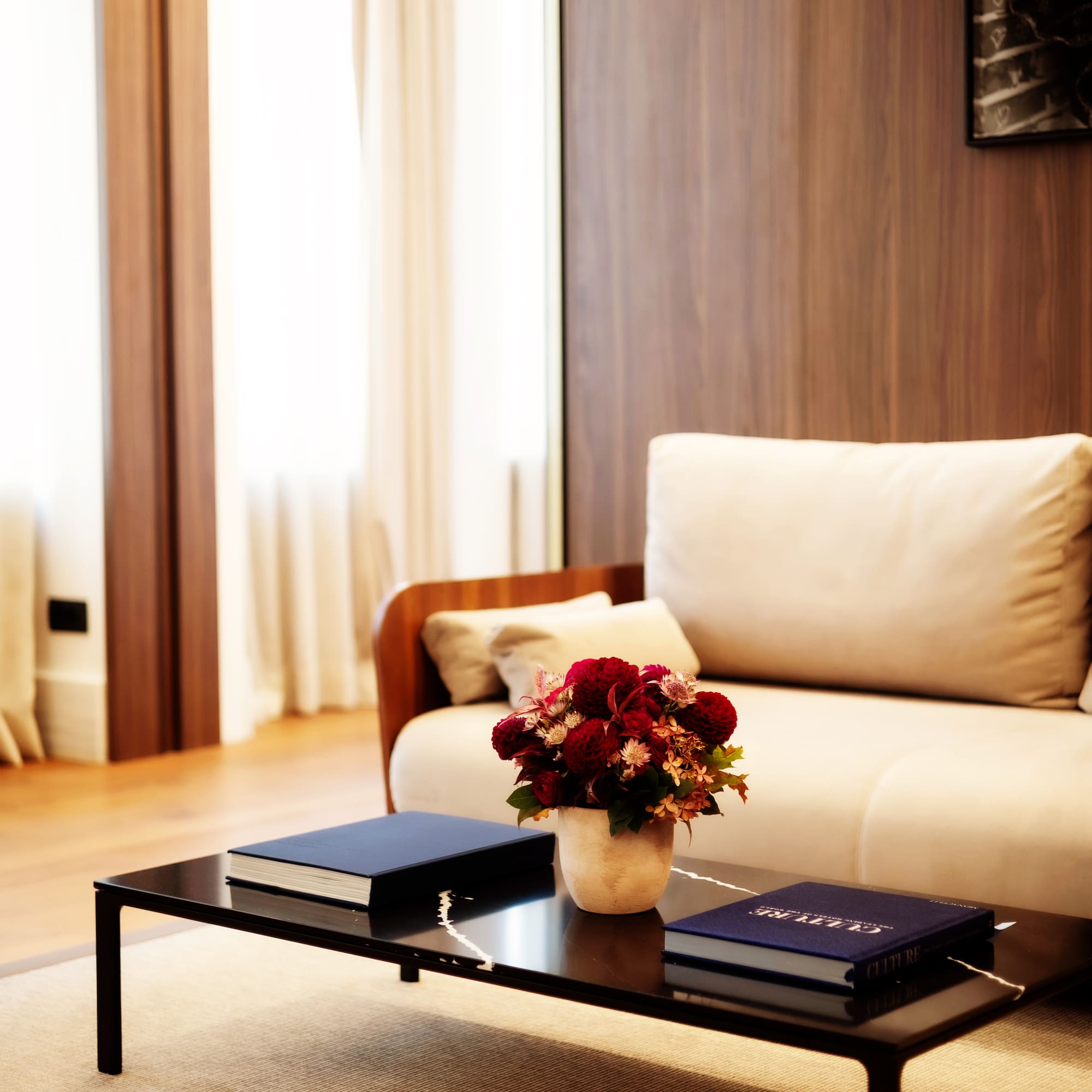a vase of flowers on a coffee table in a living room