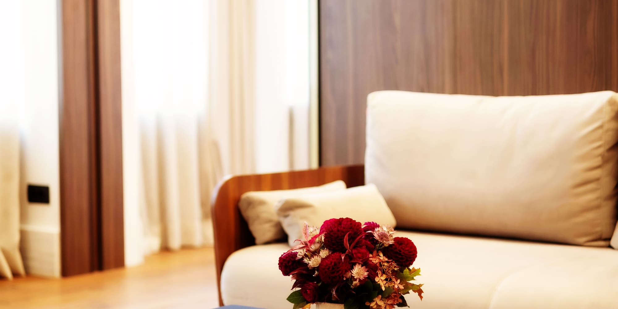 a vase of flowers on a coffee table in a living room