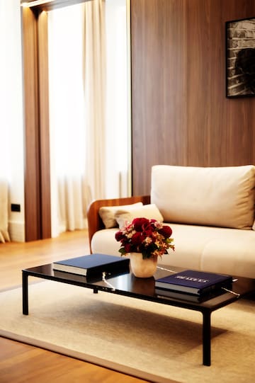 a vase of flowers on a coffee table in a living room