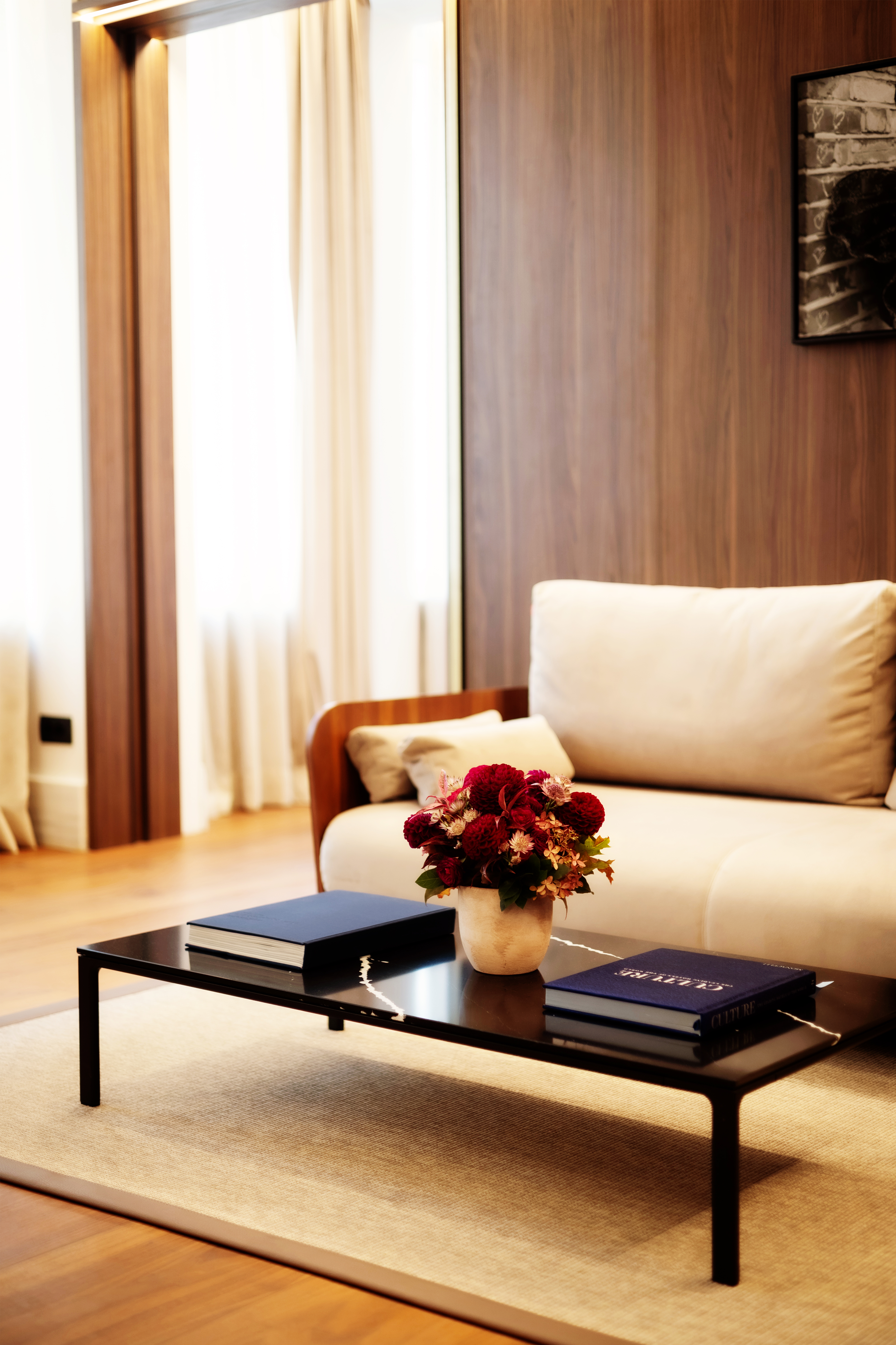 a vase of flowers on a coffee table in a living room