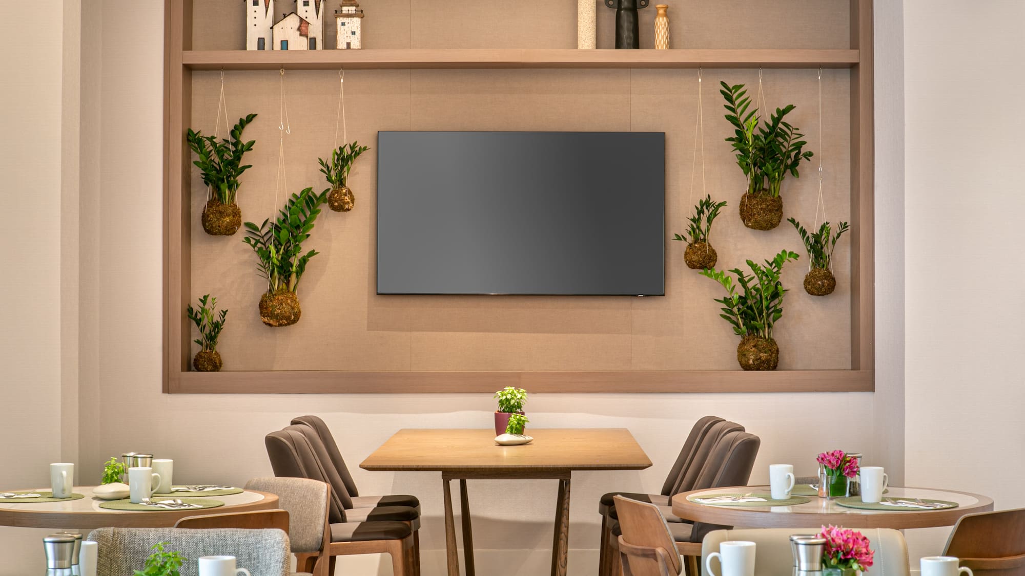 a room with tables and chairs and a television