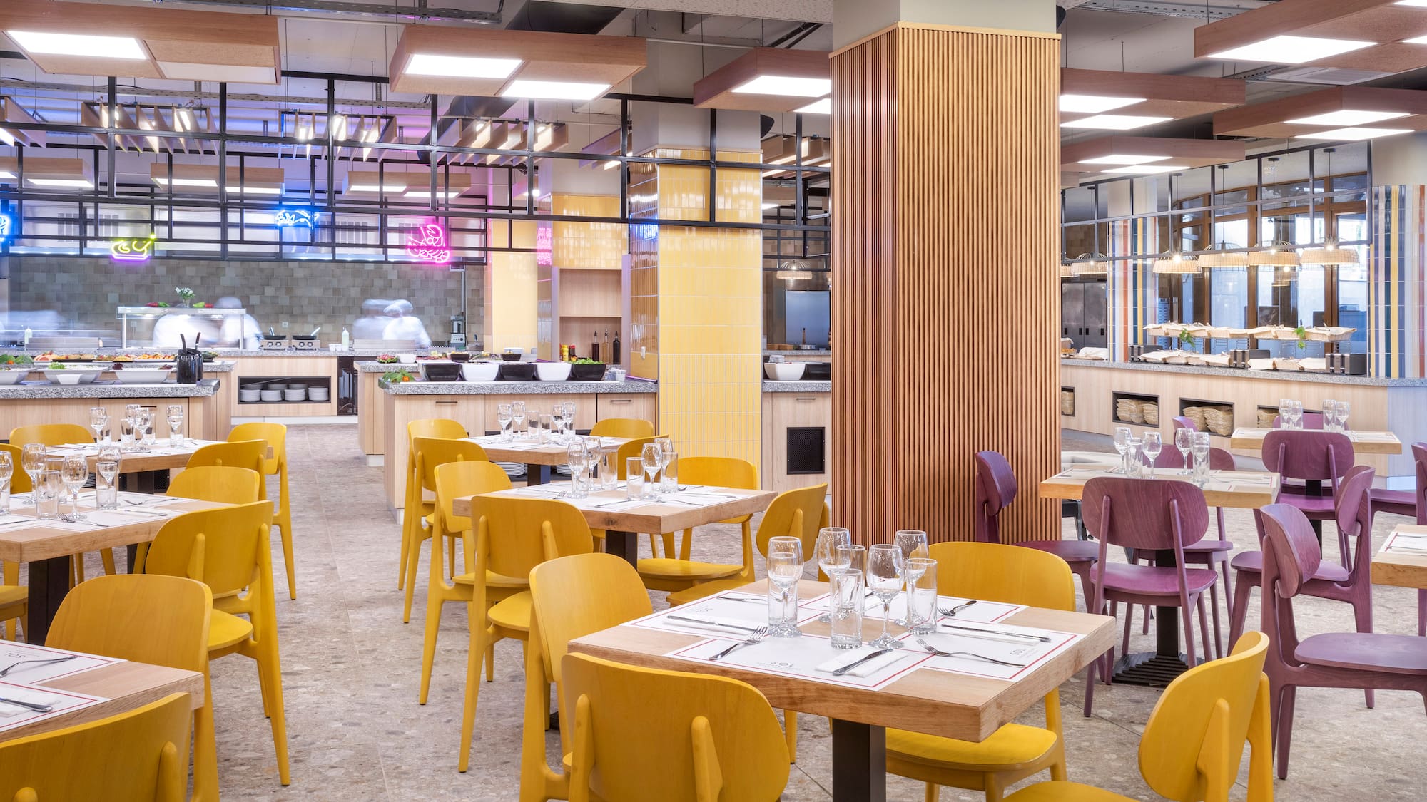 a restaurant with yellow chairs and tables