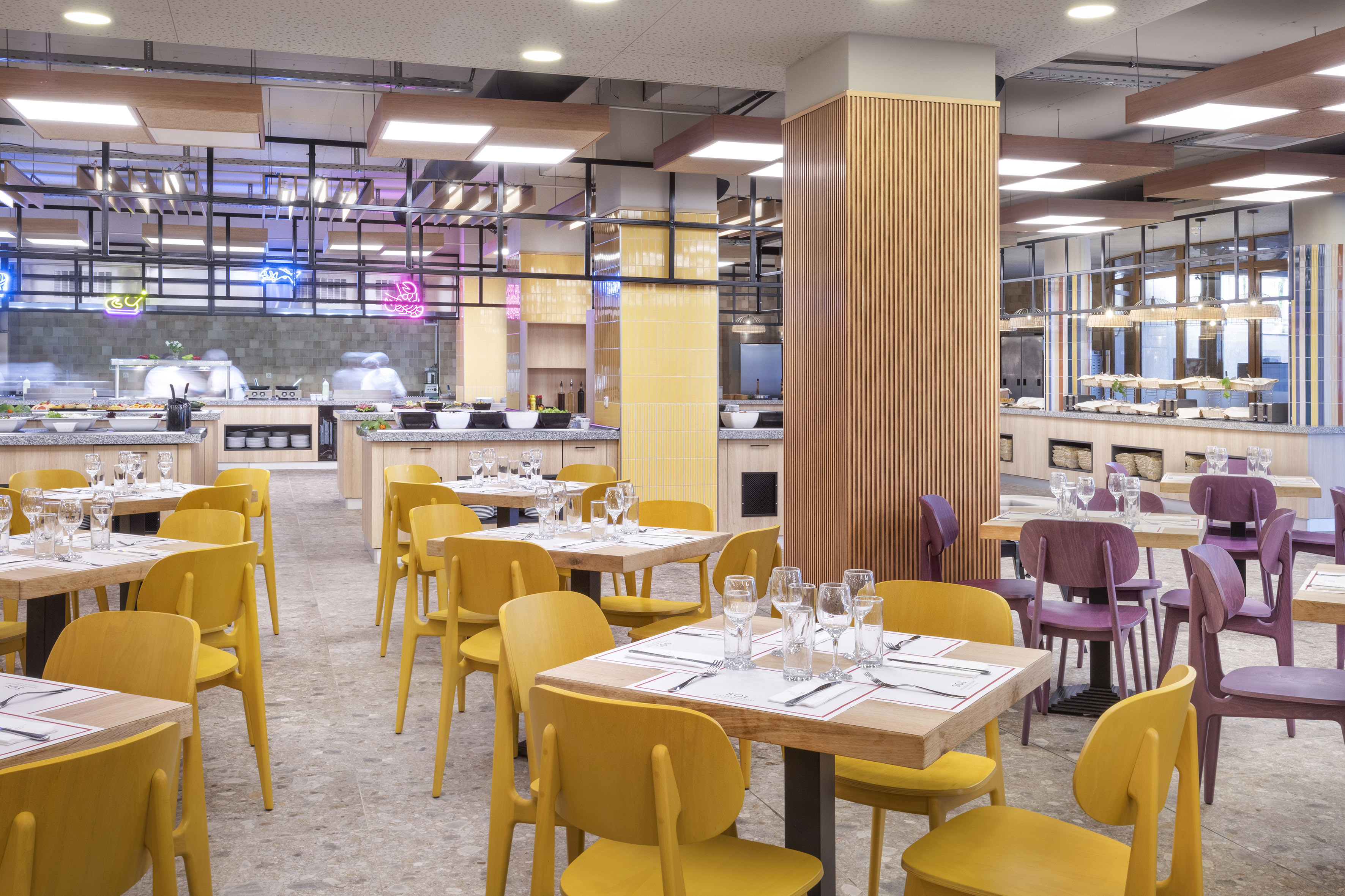 a restaurant with yellow chairs and tables