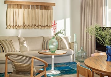 a living room with a couch and chairs