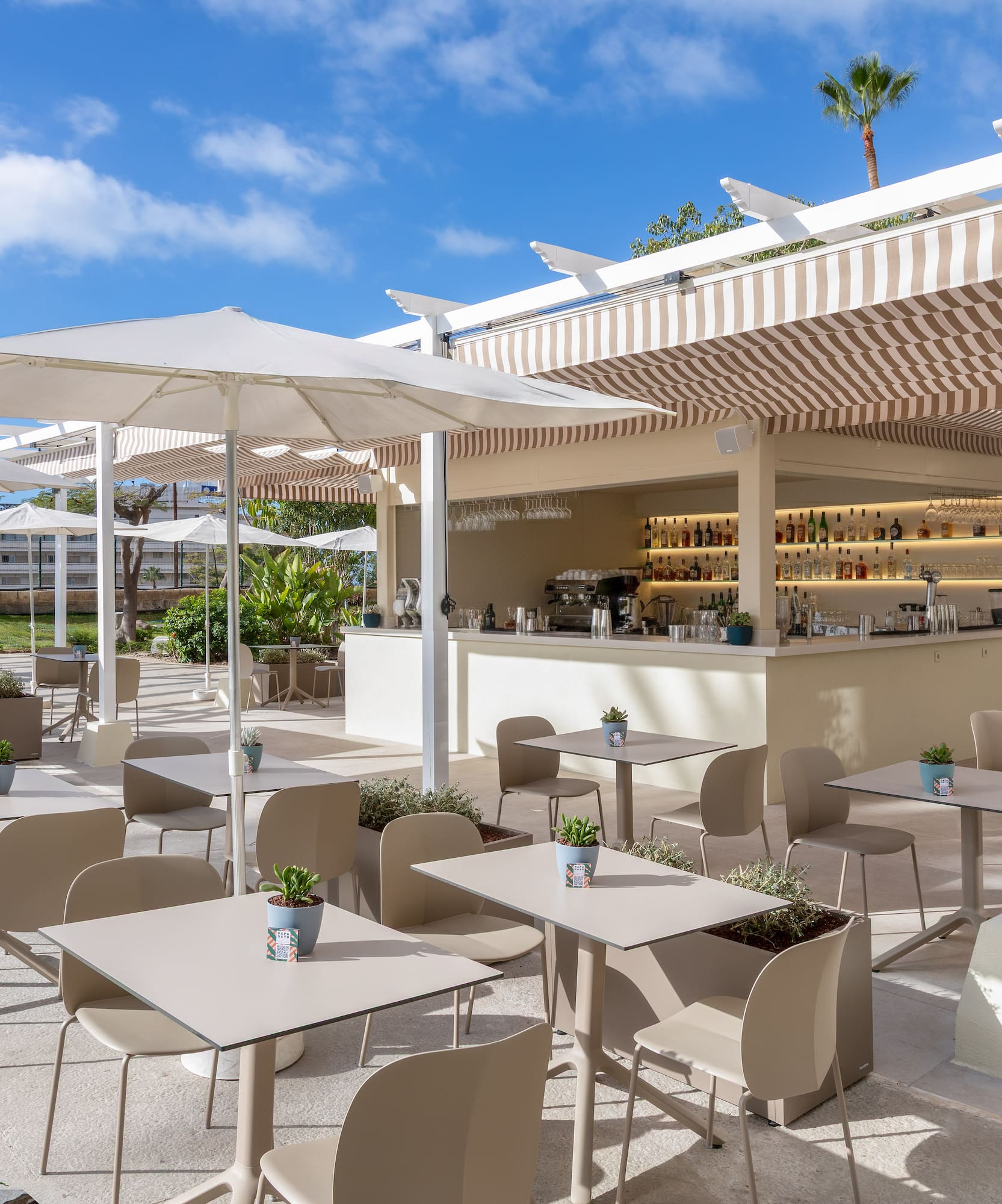 a patio with tables and chairs