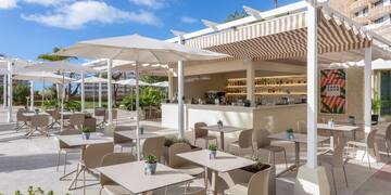 a patio with tables and chairs