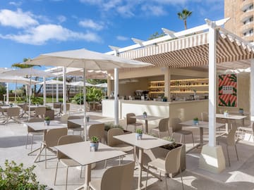 a patio with tables and chairs