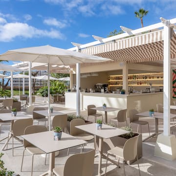 a patio with tables and chairs