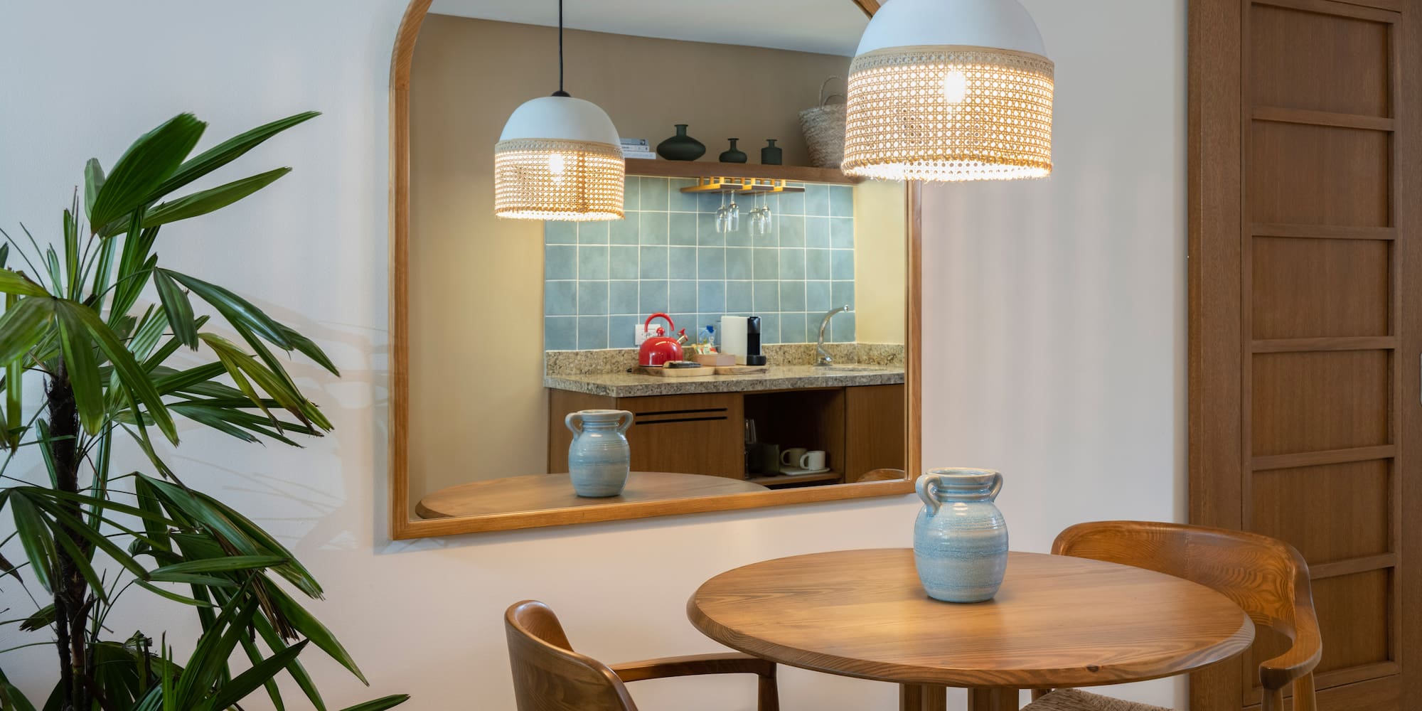 a mirror with a table and chairs