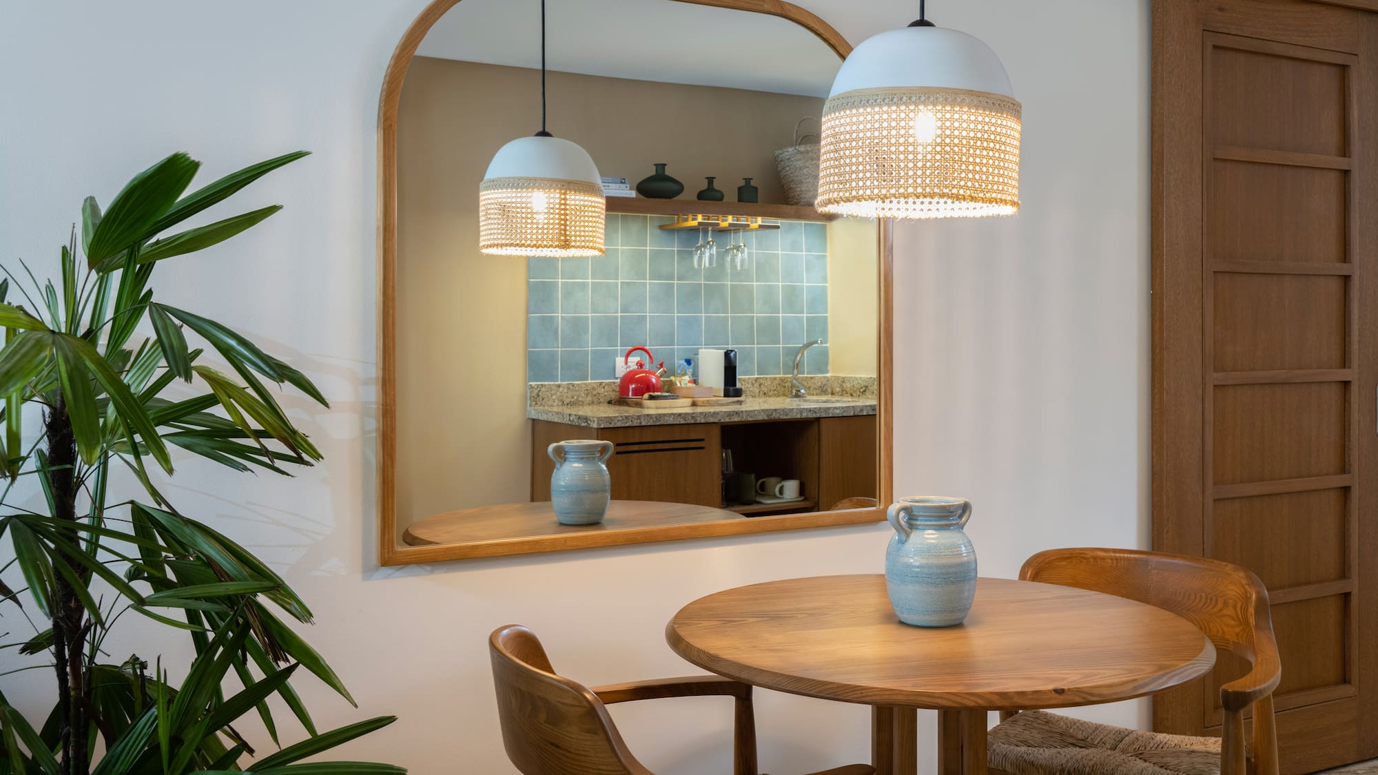 a mirror with a table and chairs