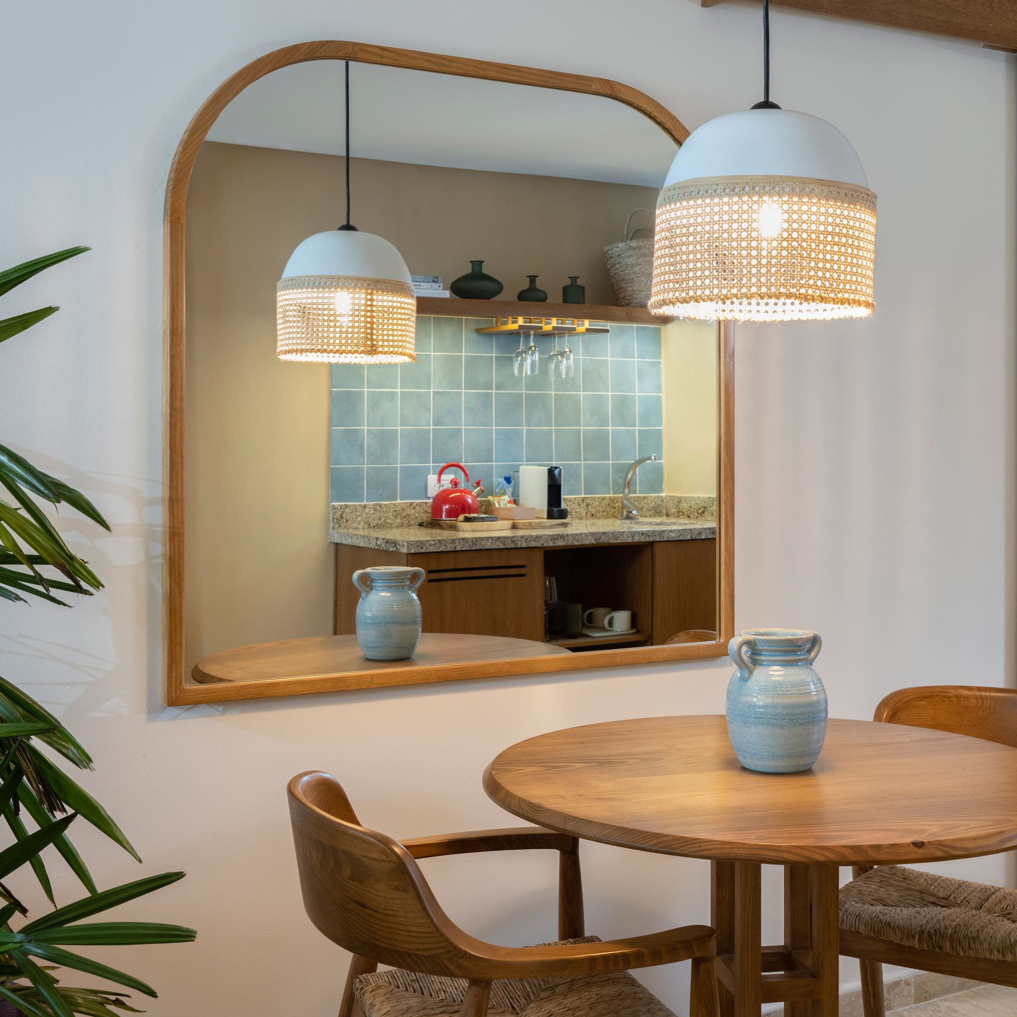 a mirror with a table and chairs