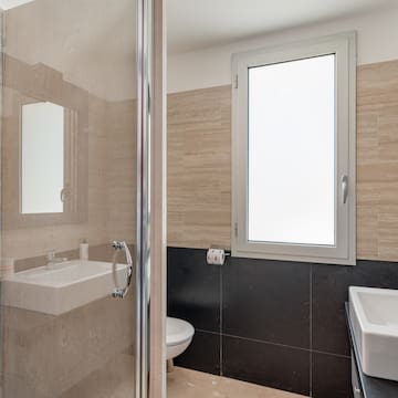 a bathroom with a glass shower door