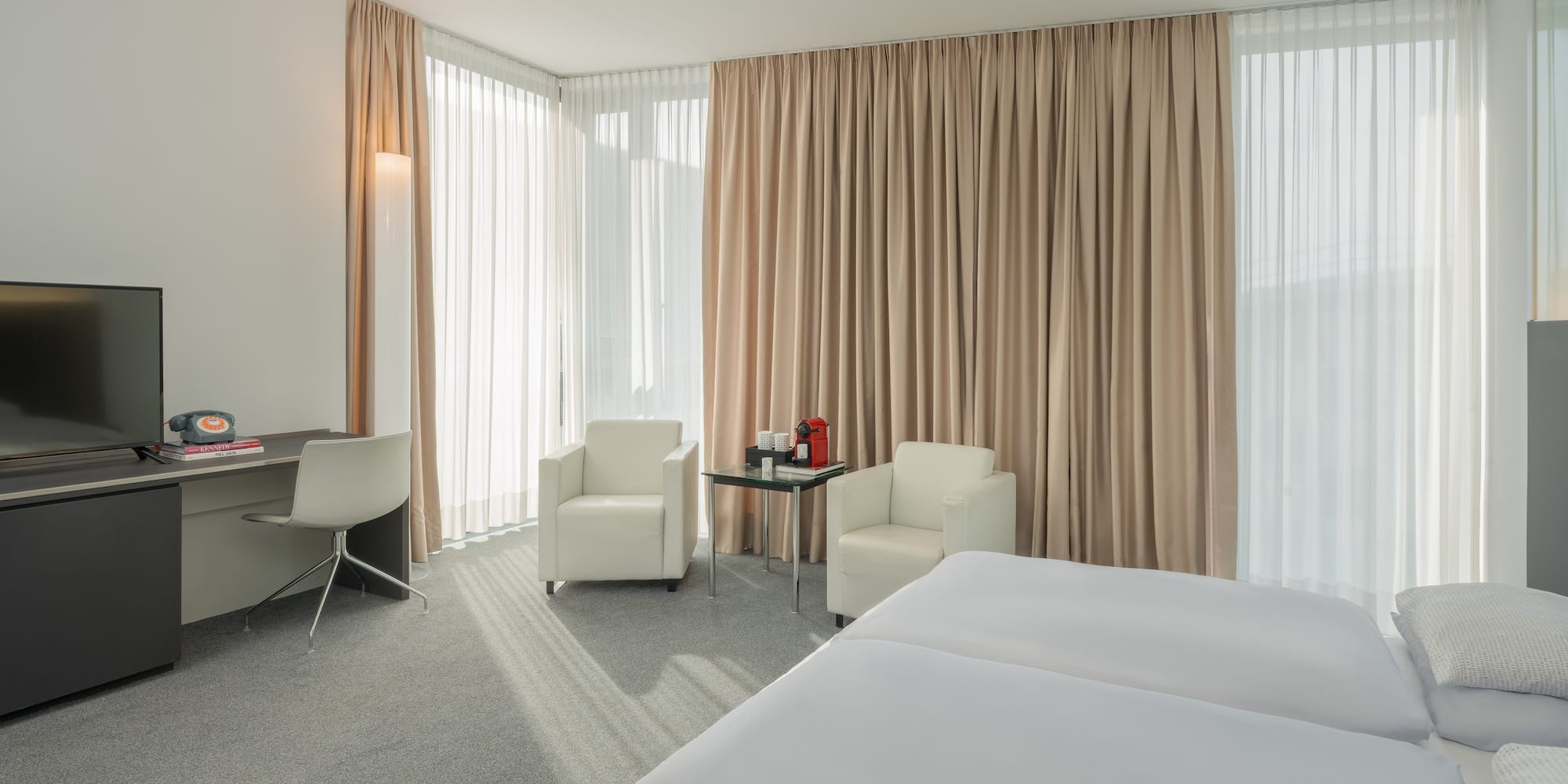 a room with a bed and chairs