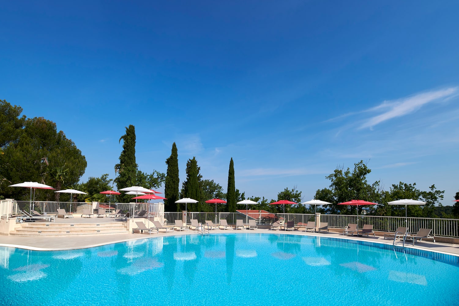 a pool with umbrellas and chairs