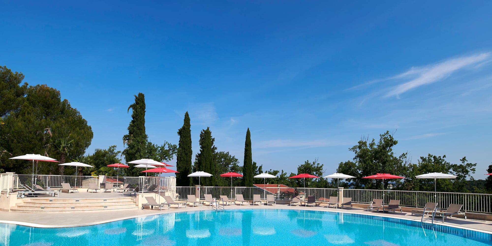 a pool with umbrellas and chairs