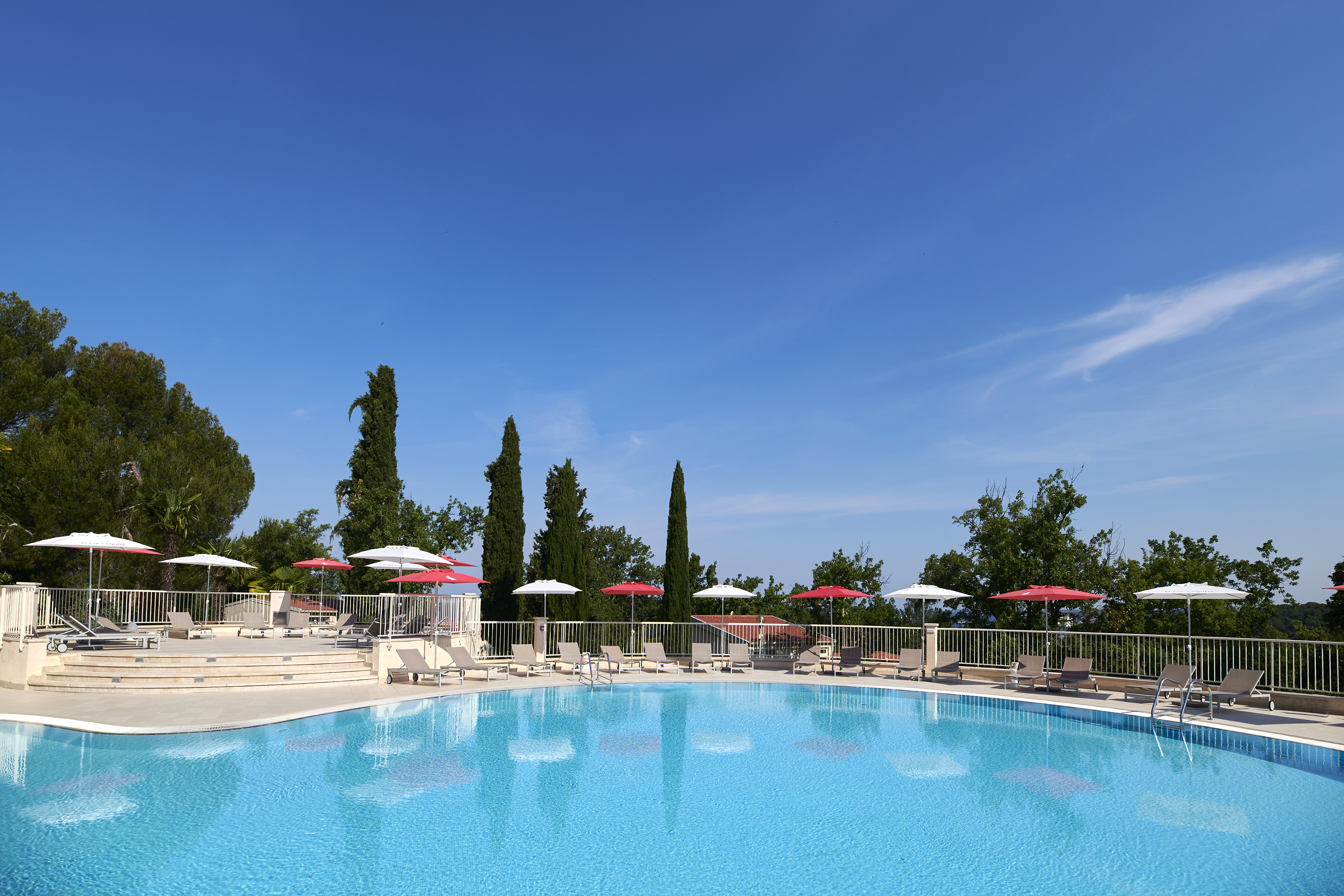 a pool with umbrellas and chairs