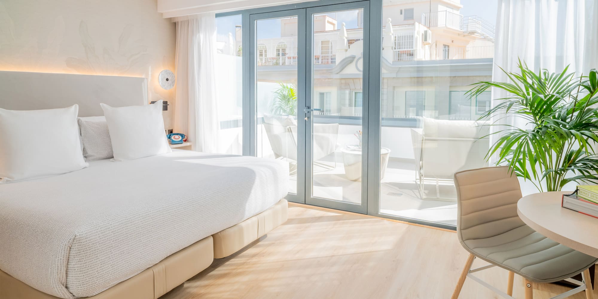 a bedroom with a large bed and a chair