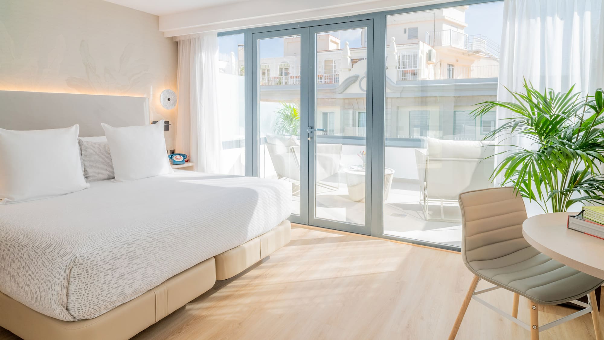 a bedroom with a large bed and a chair