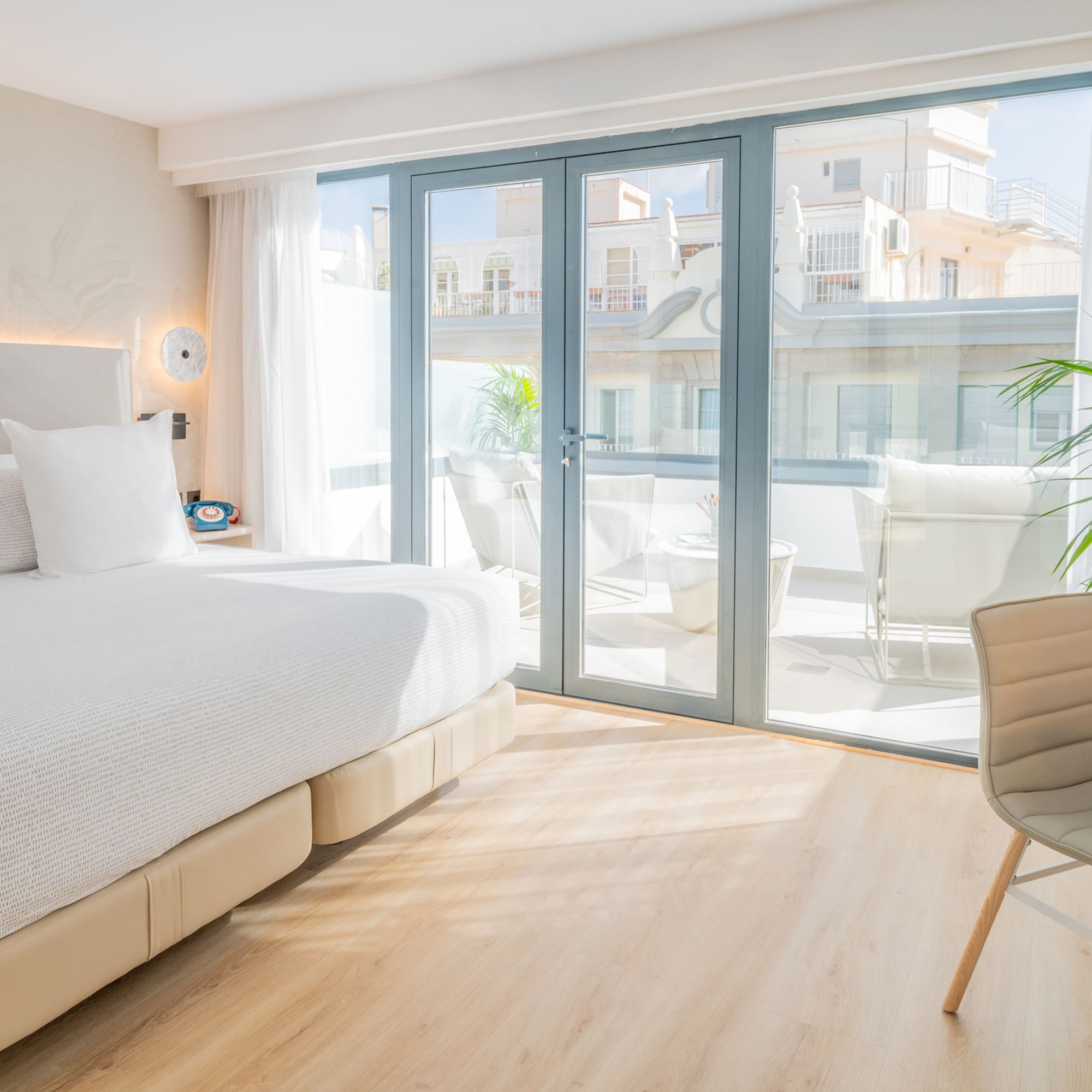 a bedroom with a large bed and a chair