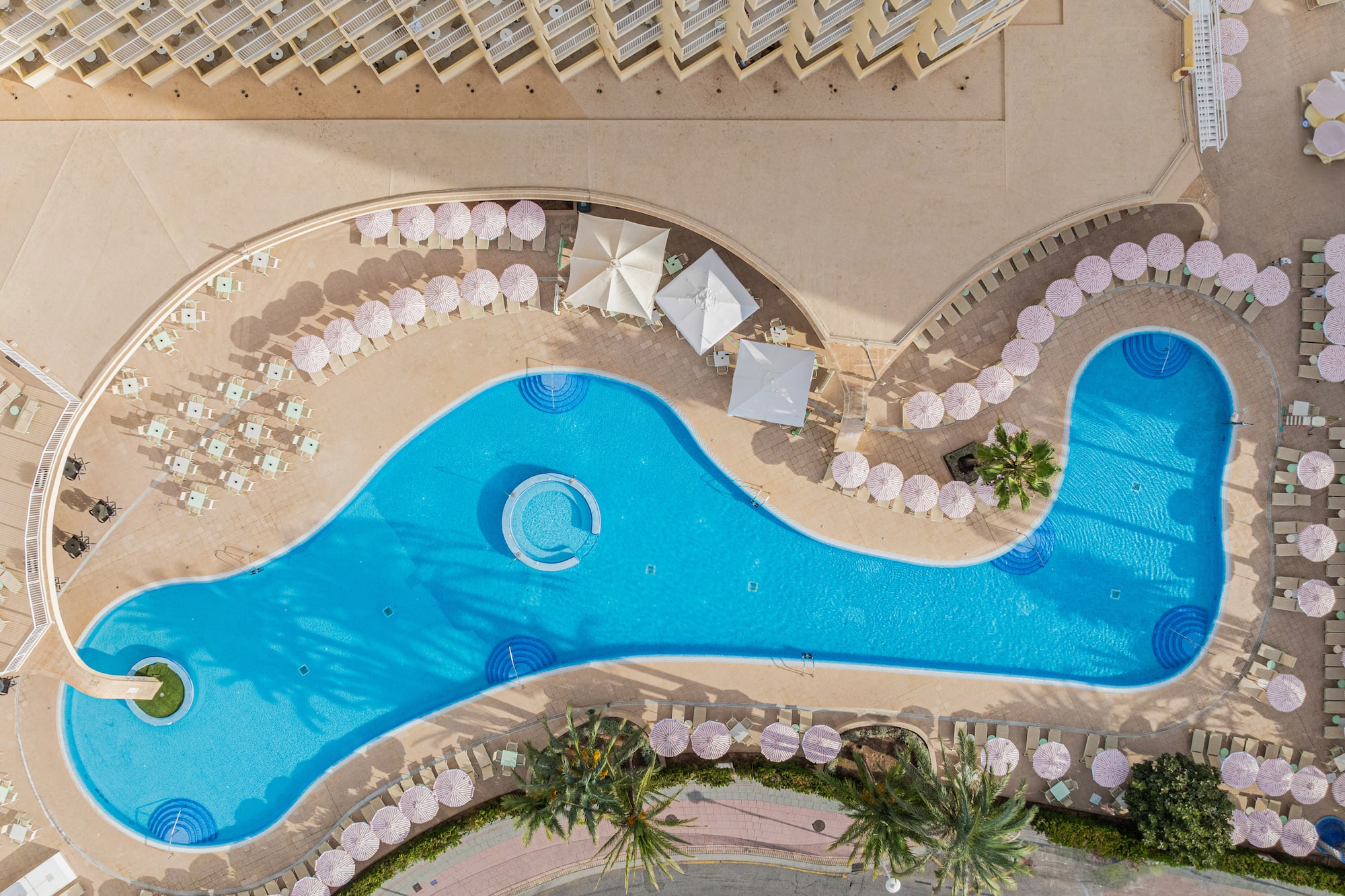 a swimming pool with umbrellas and chairs