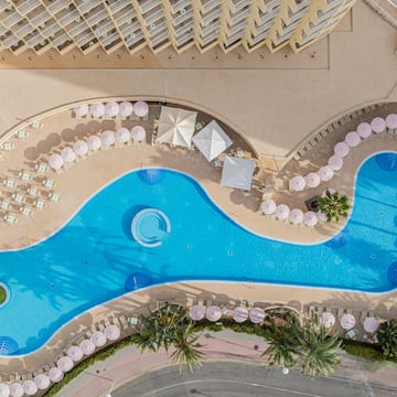 a swimming pool with umbrellas and chairs