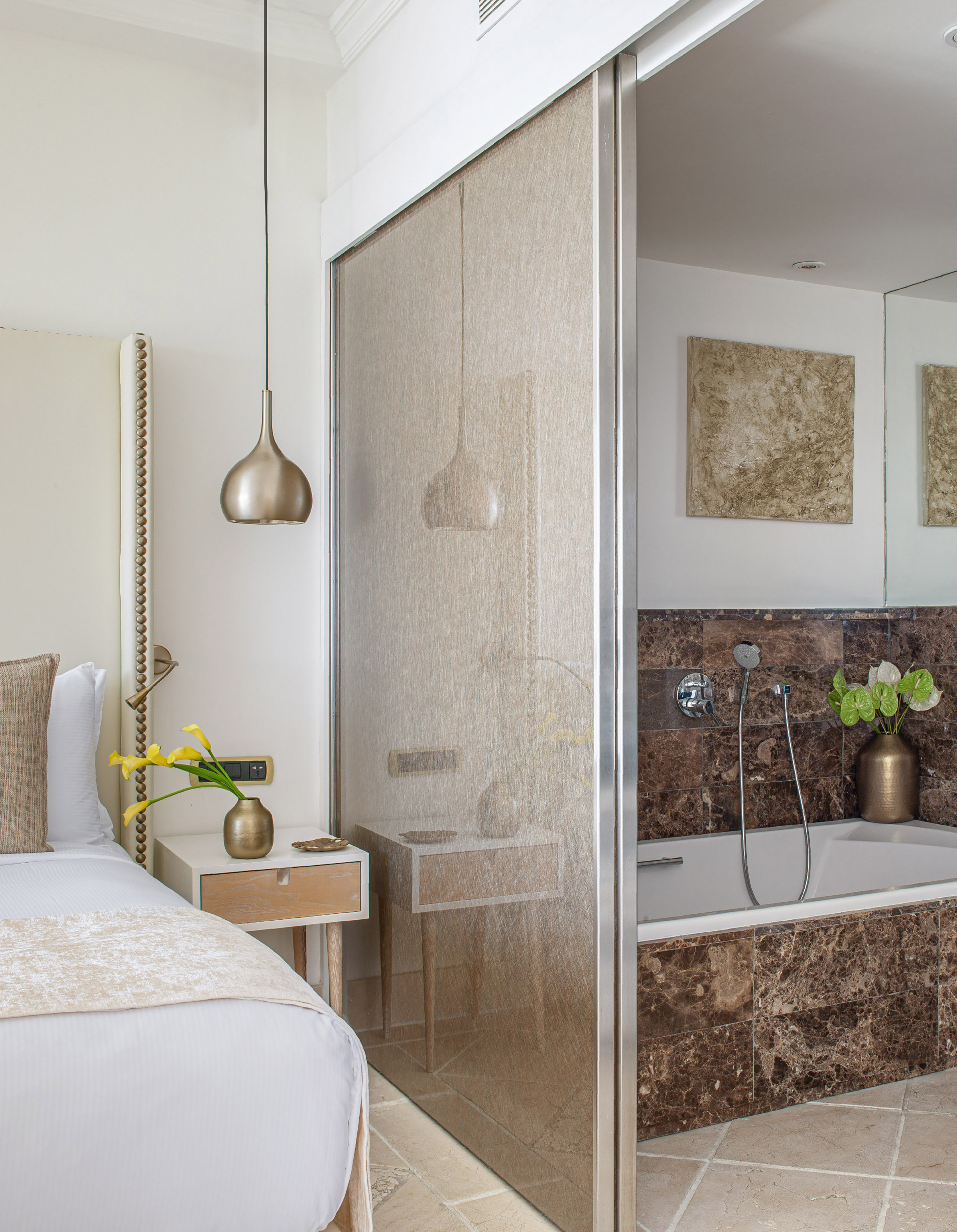 a bathroom with a shower and a bed